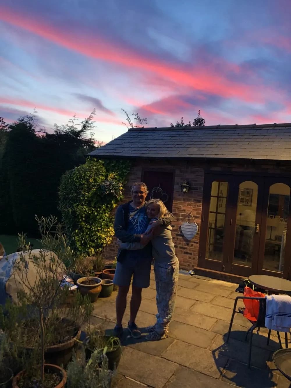Andy and Pia outside the cottage at sunset